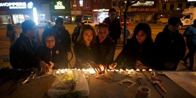 People lay candles and leave messages at a memorial for victims of a crash on Yonge St. at Finch Ave., after a van plowed into pedestrians on April 23, 2018 in Toronto.