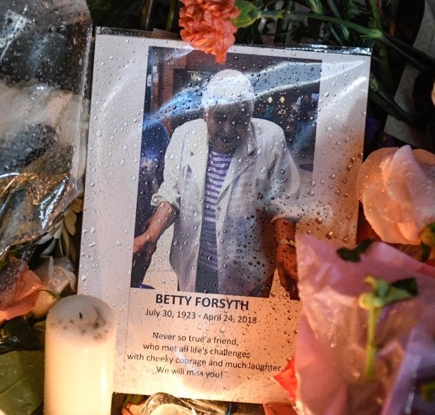 A photo of Betty Forsyth is shown at a vigil on Yonge Street in Toronto.