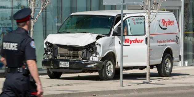 A rented van sits on a sidewalk about a mile from where several pedestrians were injured in northern Toronto, Ont. on April 23, 2018.