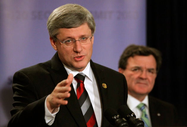 Former Prime Minister Stephen Harper, left, gestures as he speaks next to then-Finance Minister Jim Flaherty, right, at a news conference at the G20 Summit in Seoul on Nov. 12, 2010.