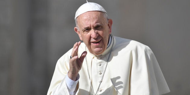 Pope Francis waves to faithful as he arrives for his weekly general audience in St Peter's square at the Vatican on April 25, 2018.