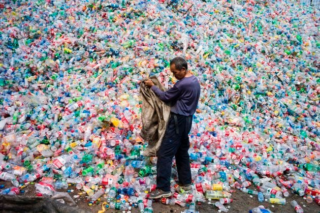 A Chinese labourer sorting out plastic bottles for recycling on the outskirt of Beijing on Sept. 17, 2015.