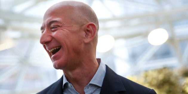 Amazon founder and CEO Jeff Bezos laughs as he talks to the media while touring the new Amazon Spheres during the grand opening at Amazon's Seattle headquarters in Seattle, Wash., Jan. 29, 2018.