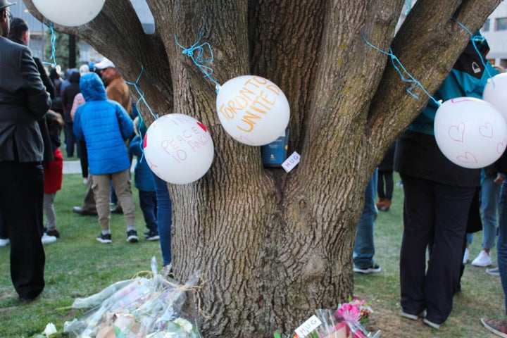 Balloons blow in the wind during a vigil for the victims of last week's deadly van attack in Toronto on April 29, 2018.