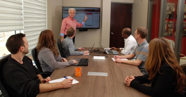 AkioSoft founder Francis Nicloux meets with his employees in their offices in Saint-Bruno-de-Montarville, Que.