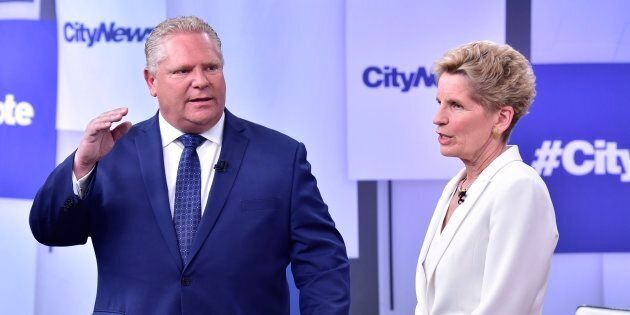 Liberal Premier Kathleen Wynne, right, and Progressive Conservative Leader Doug Ford take part in an Ontario Leaders debate in Toronto on May 7, 2018.