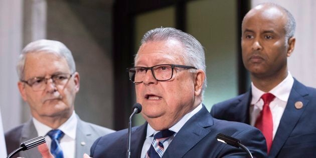 Public Safety Minister Ralph Goodale discusses the situation of irregular migration as Immigration Minister Ahmed Hussen and Transport Minister Marc Garneau look on during a news conference on May 7, 2018 near Hemmingford, Que.