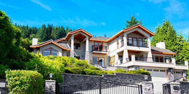 A luxury home is pictured in a wealthy subdivision in Greater Vancouver. The luxury housing markets in Toronto and Vancouver are undergoing a major correction, with sales plummeting from year-ago levels and once rapidly-rising prices now under pressure, according to new reports released this week.