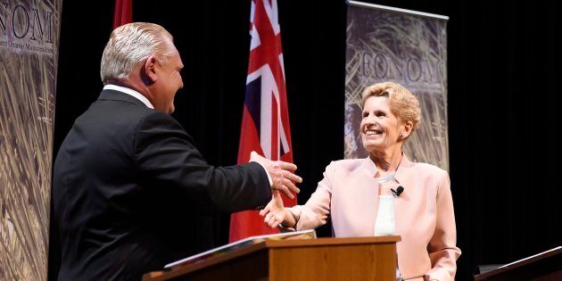 Ontario Progressive Conservative Leader Doug Ford, left, and Ontario Liberal Leader Kathleen Wynne shake hands after taking part in the second of three leaders' debate in Parry Sound, Ont. on May 11, 2018.