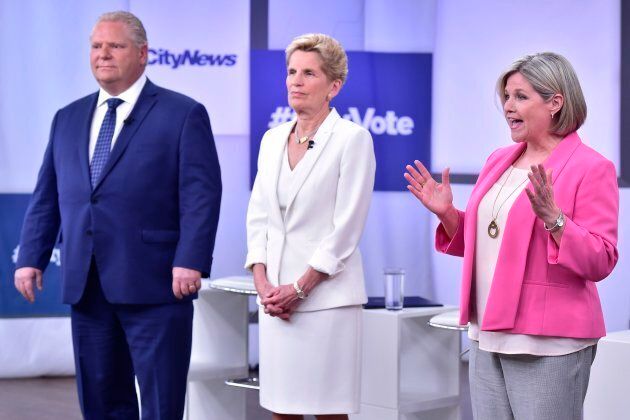 Liberal Premier Kathleen Wynne, centre, Progressive Conservative Leader Doug Ford, left, and NDP Leader Andrea Horwath stand together before the start of their debate in Toronto on May 7, 2018.