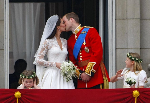 Prince William and Kate Middleton kiss on the balcony of Buckingham Palace, London.