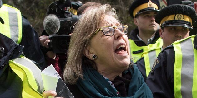 Green Party Leader Elizabeth May thanks supporters as she's arrested by RCMP officers after joining protesters outside Kinder Morgan's facility in Burnaby, B.C., on March 23, 2018.