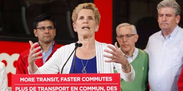 Ontario Liberal leader Kathleen Wynne speaks in front of the O-Train at a campaign stop in Ottawa on May 17, 2018.