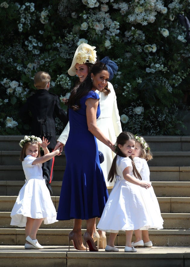 The Duchess of Cambridge and Canadian stylist Jessica Mulroney hold bridesmaids hands as they arrive for the wedding.