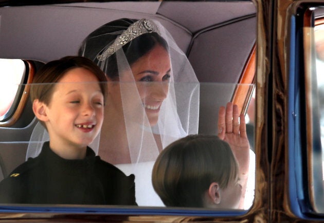 Page boys John and Brian Mulroney with Meghan Markle as she arrives in a car for her wedding to Prince Harry on Saturday.