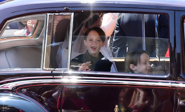 Page boys John and Brian Mulroney accompany Meghan Markle as she arrives in a car for the wedding ceremony to marry Britain's Prince Harry, Duke of Sussex, at St George's Chapel, Windsor Castle, in Windsor, on May 19, 2018.