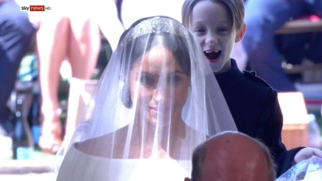 An excited Mulroney twin helps Meghan Markle into the chapel on Saturday.