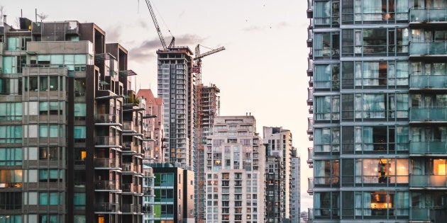 A neighbourhood of high-rise condo buildings in downtown Vancouver. New research suggests Canadians who live in more dense, more expensive neighbourhoods tend to be less happy than those in rural areas.