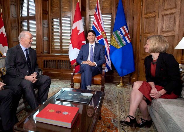Prime Minister Justin Trudeau, B.C. Premier John Horgan, left, and Alberta Premier Rachel Notley, sit in Trudeau's office on Parliament Hill for a meeting on the deadlock over Kinder Morgan's Trans Mountain pipeline expansion, in Ottawa on April 15, 2018.