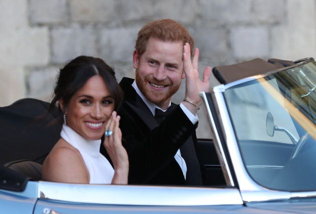 Meghan Markle and Prince Harry wave as they leave Windsor Castle after their wedding.