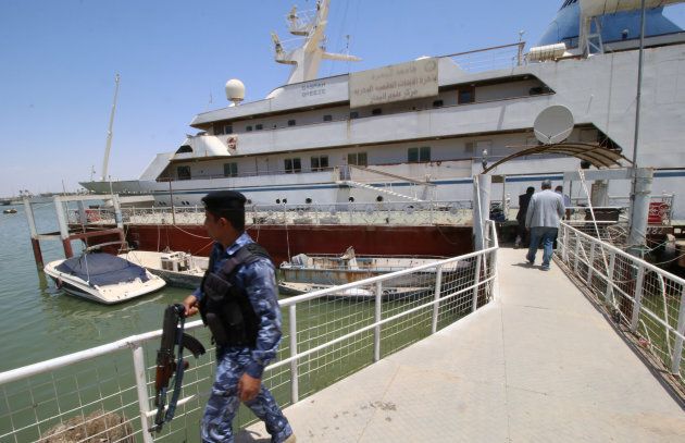 An Iraqi policeman walks past the yacht called "Basrah Breeze", once owned by former Iraqi president Saddam Hussein, in Basra, Iraq May 14, 2018.