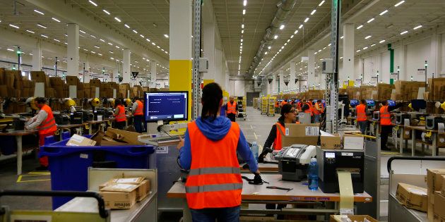 Workers handle items for delivery at an Amazon distribution center near Berlin, Germany, Nov. 28, 2013. Amazon is planning to build a one million-square-foot distribution centre in Ottawa's east end, according to news reports.