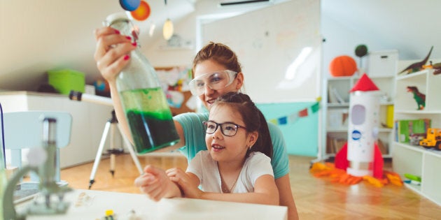 Girl and her mother doing scientific experiment