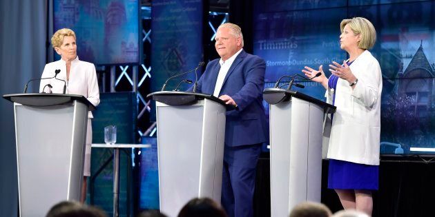Ontario NDP Leader Andrea Horwath, right, speaks as Ontario Liberal Leader Kathleen Wynne, left, and Ontario Progressive Conservative Leader Doug Ford look on during the third and final televised debate of the provincial election campaign in Toronto on May 27, 2018.