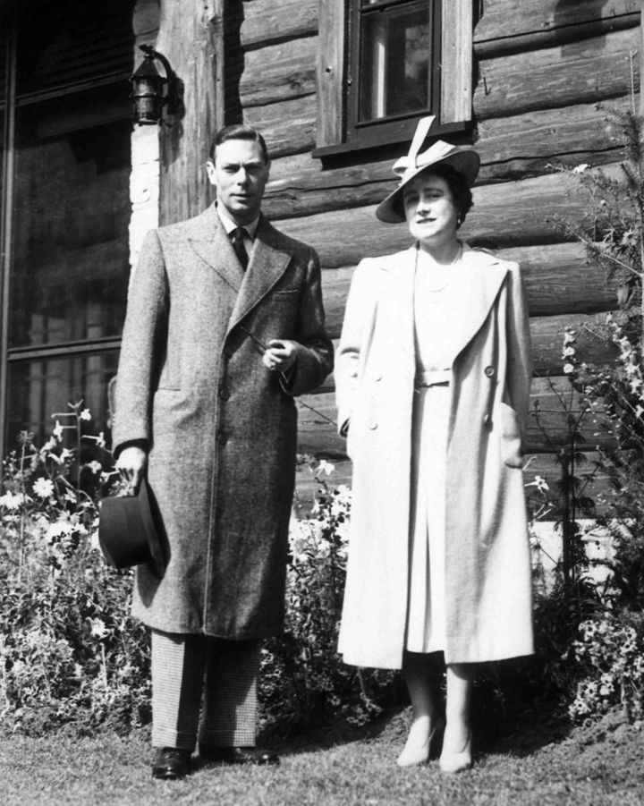 Britain's King George VI and his wife Queen Elizabeth stand outside the Jasper Park Lodge, Alberta, May 1939, during their journey through The Rockies.