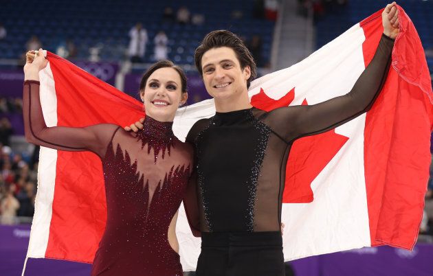 Gold medallists Tessa Virtue and Scott Moir celebrate at the Pyeongchang 2018 Winter Olympics in Gangneung, South Korea, Feb. 20, 2018