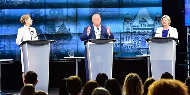 Ontario Progressive Conservative Leader Doug Ford, centre, speaks as Ontario Liberal Leader Kathleen Wynne, left, and Ontario NDP Leader Andrea Horwath look on during the third and final televised debate of the provincial election campaign in Toronto on May 27, 2018.