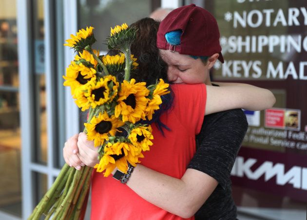 Caspen Becher (R) a freshman at Marjory Stoneman Douglas High School is hugged as she joins with others for a 'die'-in' protest in a Publix supermarket on May 25, 2018 in Coral Springs, Florida. The activists, many of whom were students, entered the Publix store to protest against the company's support of political candidates endorsed by the National Rifle Association who oppose gun reform.