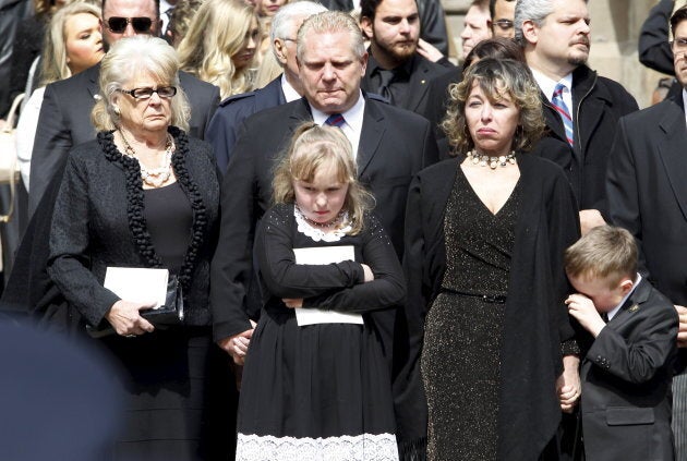 Renata Ford her daughter Stephanie and son Doug Ford Junior stand outside St James Cathedral with Doug Ford and his mother as the hearse leaves carrying former mayor Rob Ford, in Toronto on March 30, 2016.