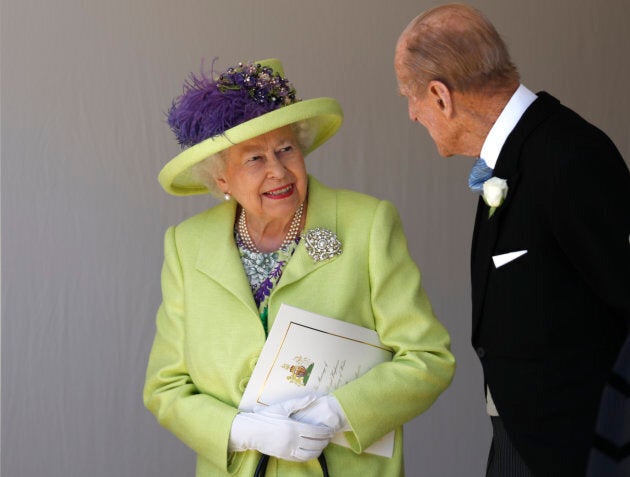 Queen Elizabeth II talks with Prince Philip as they leave the wedding ceremony of Prince Harry and Meghan Markle at St George's Chapel.