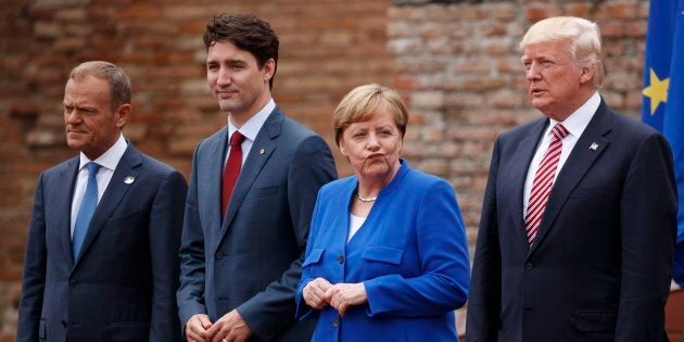 Leaders of the G7, from left, European Council President Donald Tusk, Prime Minister Justin Trudeau, German Chancellor Angela Merkel, and President Donald Trump pose for a family photo at the Ancient Greek Theater of Taormina on May 26, 2017, in Taormina, Italy.