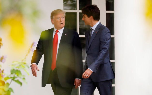U.S. President Donald Trump walks down the White House colonnade to the Oval Office with Prime Minister Justin Trudeau.