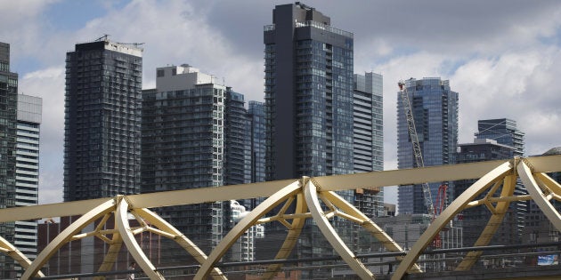 A pedestrian bridge in front of condominium buildings in downtown Toronto, Thurs. May 10, 2018. The Bank of Canada says condos have become the latest target of real estate speculators, making them a more risky investment.