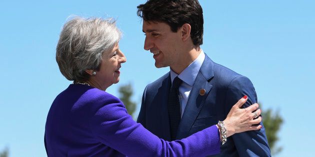 Prime Minister of Canada Justin Trudeau greets British Prime Minister Theresa May during the G7 in La Malbaie, Que. on June 8, 2018.
