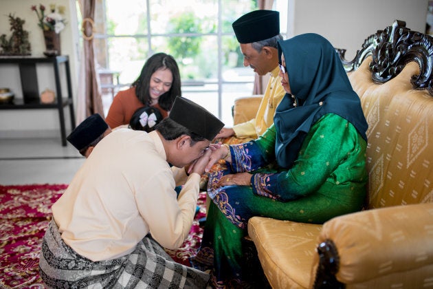 Son asking his mother for forgiveness as part of the the Islamic celebration of Eid al-Fitr in Malaysia.