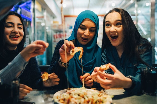 Muslim friends eating at a cafe.