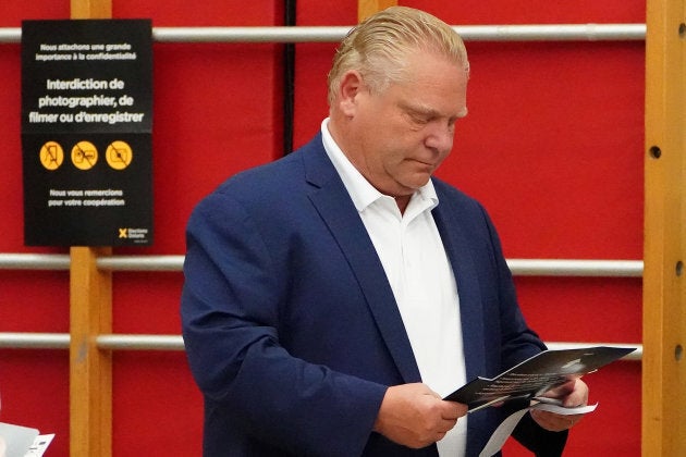 Progressive Conservative leader Doug Ford checks his ballot as he votes in Toronto on June 7, 2018.