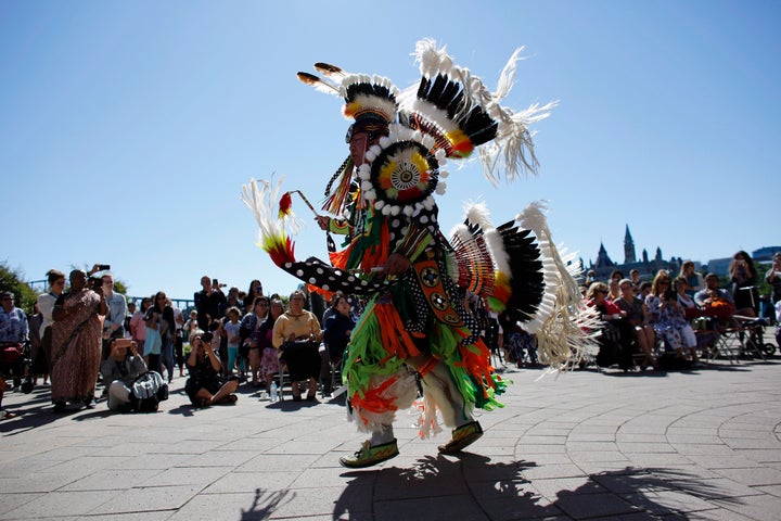 A traditional dance is performed on National Indigenous Peoples Day behind the Canadian Museum of History in Gatineau, Que. today.