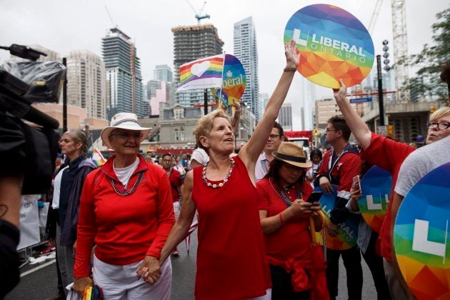 Ontario Premier Kathleen Wynne marches alongside her partner Jane Rounthwaite during the Toronto Pride parade on June 24, 2018 in Toronto.