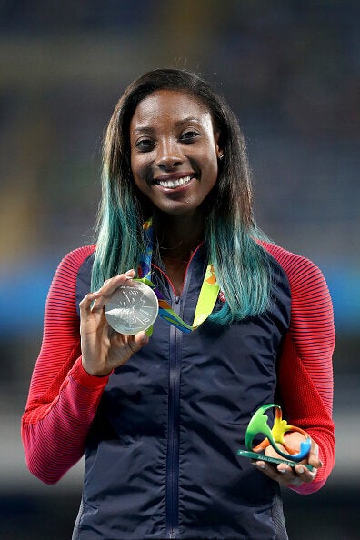 Nia Ali of the U.S. poses on the podium during the medal ceremony for the women's 100-metre hurdles at the Rio 2016 Olympic Games.