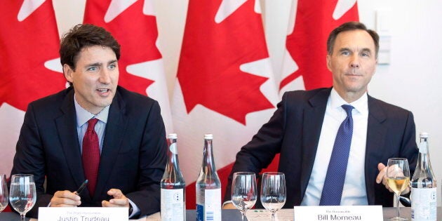 Prime Minister Justin Trudeau (left) sits next to Federal Finance Minister Bill Morneau during a round table discussion at the Canadian Transformational Infrastructure Summit and the Canlnfra Challenge, Toronto, Tues. May 29, 2018.