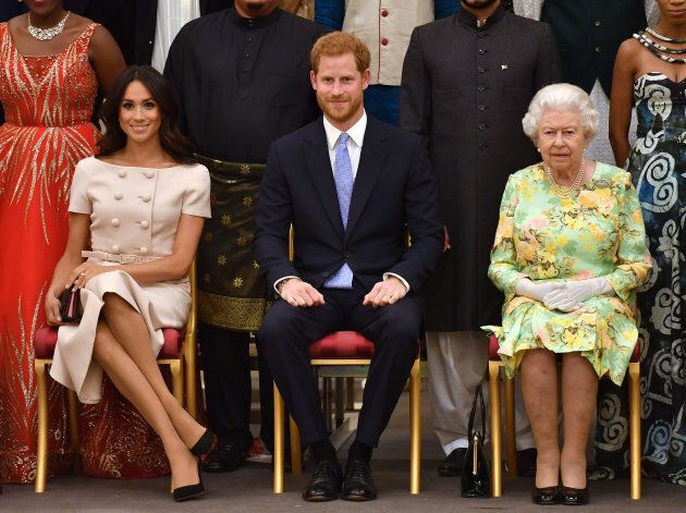 Queen Elizabeth II with the Duke and Duchess of Sussex during a group photo at the Queen's Young Leaders Awards Ceremony at Buckingham Palace, London.
