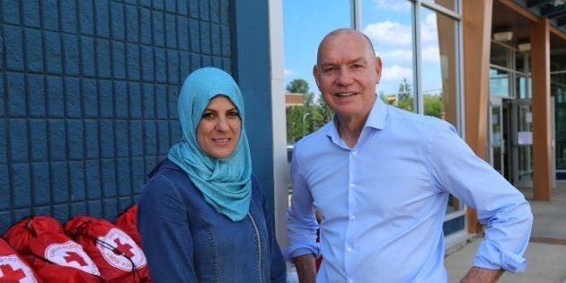 Canadian Red Cross President and CEO Conrad Sauvé with Fort McMurray resident and small business owner Rewaida Assaf.