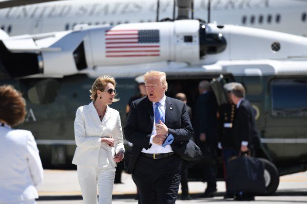U.S. President Donald Trump with U.S. Ambassador to Canada Kelly Knight Craft walks to Air Force One prior to departure from CFB Bagotville in Quebec on June 9, 2018.