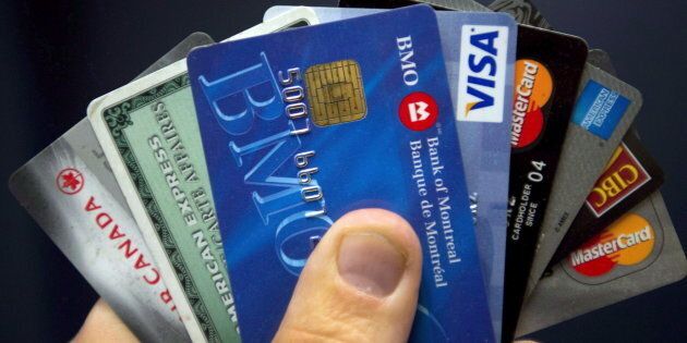 Fewer Canadians are paying off their credit cards in full, a sign that debt delinquencies could soon be on the rise, credit rating agency Equifax says.