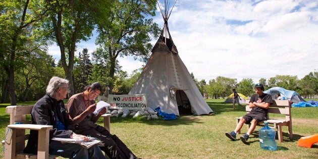 Chris Blondeau-Perry, left, an 88-year-old Metis woman from Weyburn, Sask., and Prescott Demas, second from left, both supporters of the